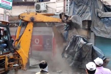 Thane civic body demolishes illegal shop extensions  