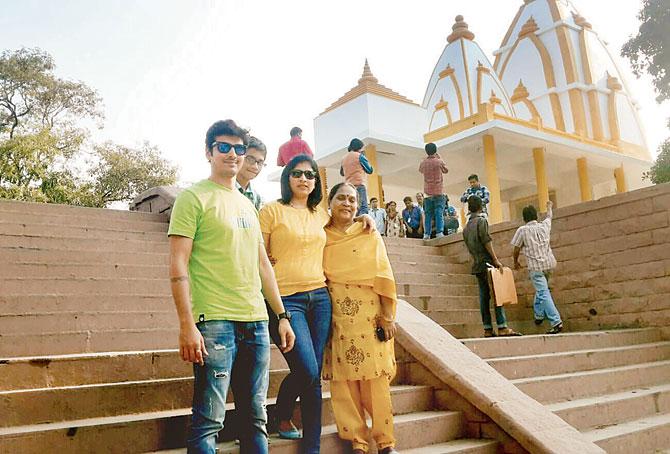 Tourists pose outside Filmcity’s popular temple seen in daily soaps and movies