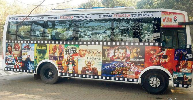 Tourists travel inside Filmcity in a Bollywood-themed tour bus