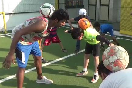 Football freestyle champ Archis Patil shows off his tricks to kids