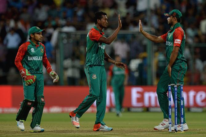 Bangladesh bowler Al-Amin Hossain (C) celebrates with teammates