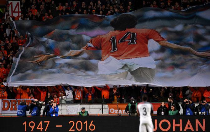 A large banner is displayed during a standing ovation in honour of late Dutch football legend Johann Cruyff during a pause in the 14th minute of the friendly football match between the Netherlands and France
