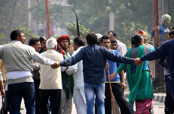 Residents form a human chain on a street following fatal caste protests in Rohtak in February. AFP PHOTO / STR / AFP / STRDEL
