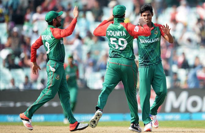 Mustafizur Rahman celebrates a wicket with teammates