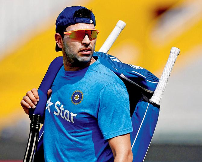 Yuvraj Singh walks with his equipment at the Punjab Cricket Association Stadium in Mohali near Chandigarh on Saturday. Pic/AFP