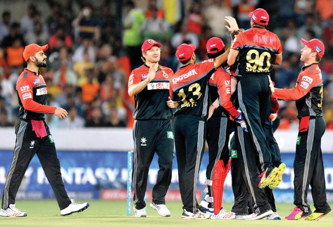 RCB players led by captain Virat Kohli extreme left celebrate the wicket of a Sunrisers Hyderabad batsman during an Indian Premier League  match at the Rajiv Gandhi International Stadium in Uppal, Hyderabad on Saturday. Sunrisers Hyderabad won by 15 runs. pic/AFP 