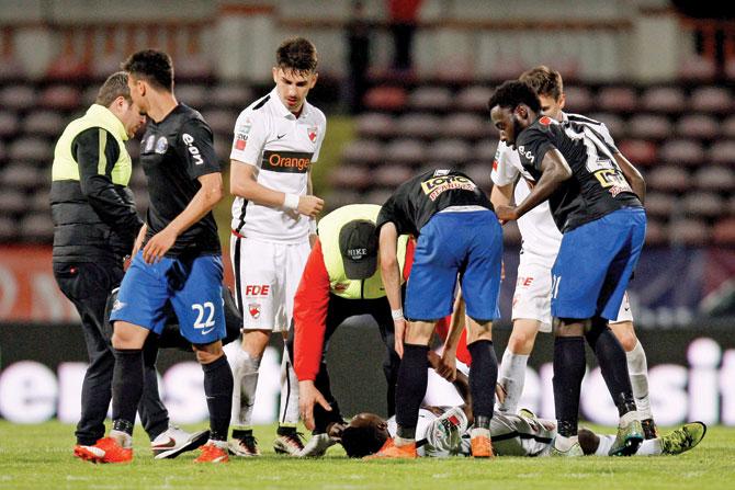 Member of the medical staff tries to revive Cameroon’s Patrick Ekeng as he lies on the pitch after collapsing during a football match in Bucharest, Romania on Friday. pic/AFP