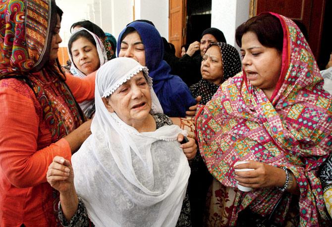 Family members mourn the death of activist Khurram Zaki. PIC/AP