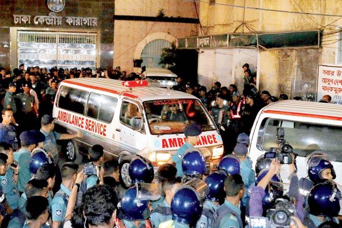 Security personnel cordon an ambulance carrying the body of Motiur Rahman Nizami. Pic/AP