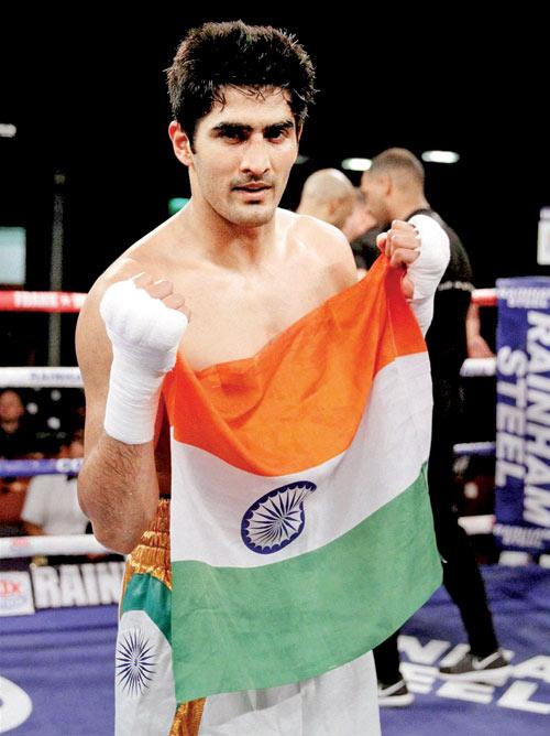 Vijender Singh celebrates his knockout win over Poland’s Andrzej Soldra in the Pro Boxing bout at Bolton on Friday. — PTI