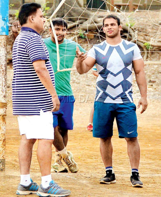 Narsingh chats with coach GS Sangha (left) at the Sports Authority of India ground, Kandivli on Saturday. Pic/Ajinkya Sawant
