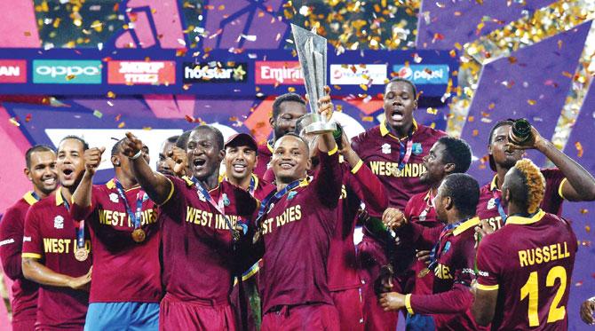 West Indies players pose with the ICC World T20 trophy after their win over England in the final at Kolkata on April 3. Pic/PTI 