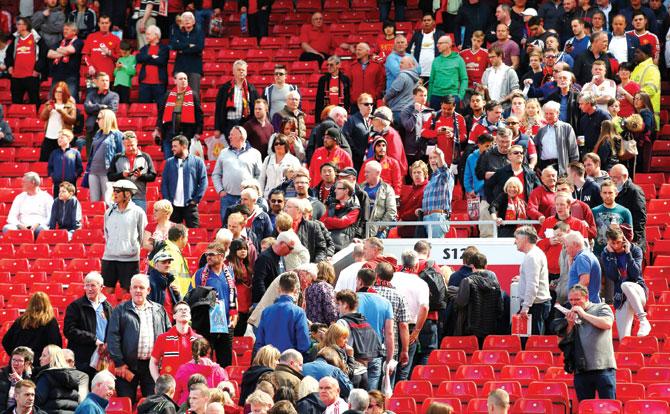 Ground staff evacuate fans after the EPL match between Manchester United and Bournemouth is abandoned following a bomb scare at Old Trafford in Manchester on Sunday.  Pics/Getty Images