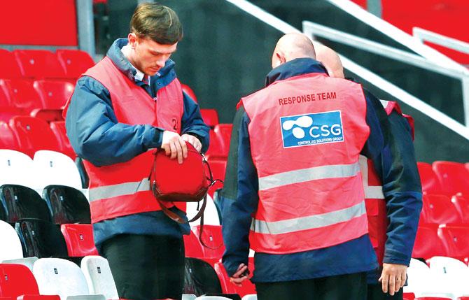 A security team examine an abandoned bag at Old Trafford