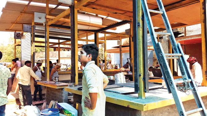 Workers reconstruct food stalls gutted in the April 22 fire 