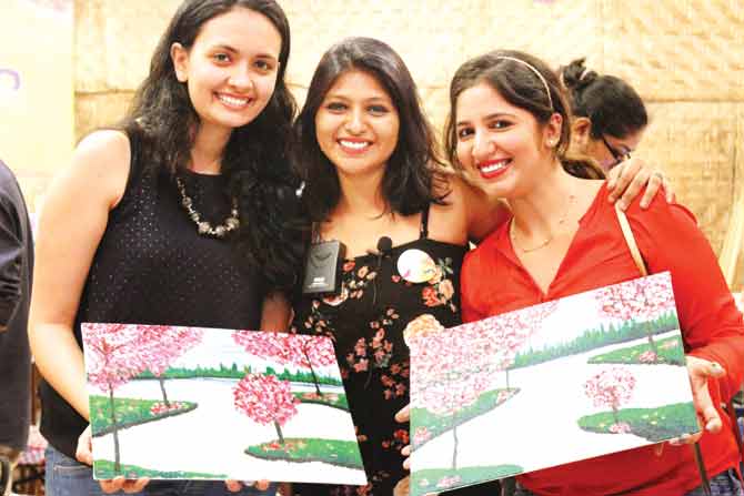 Art Jam participants show off their paintings