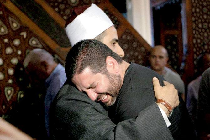 The Imam of al Thawrah Mosque, Samir Abdel Bary, condoles film director Osman Abu Laban, who lost 4 relatives in the crash. Pic/AP