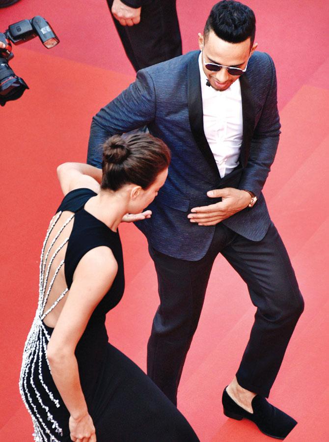 May I help you?: Irina Shayk is helped by Lewis Hamilton taking on the stairs during the red carpet for the 69th annual Cannes Film Festival. Pics/Getty Images