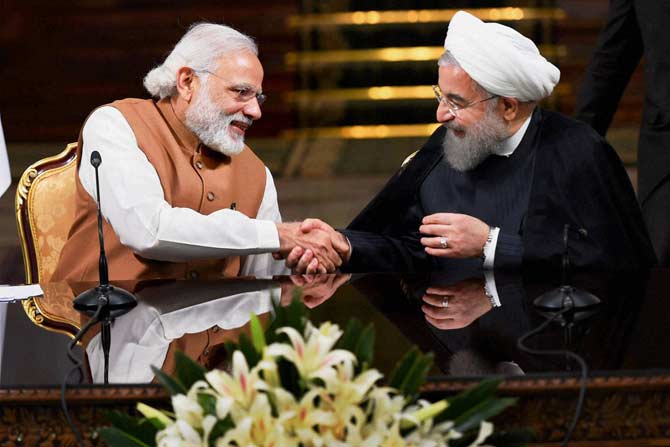 Prime Minister Narendra Modi shakes hands with Iranian President Hassan Rouhan. Pic/ PTI