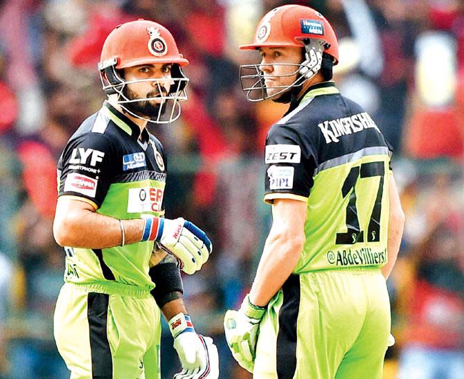Royal Challengers Bangalore skipper Virat Kohli (left) and AB de Villiers during their record 229-run stand against Gujarat Lions at the M Chinnaswamy Stadium in Bangalore on May 14. Pic/PTI