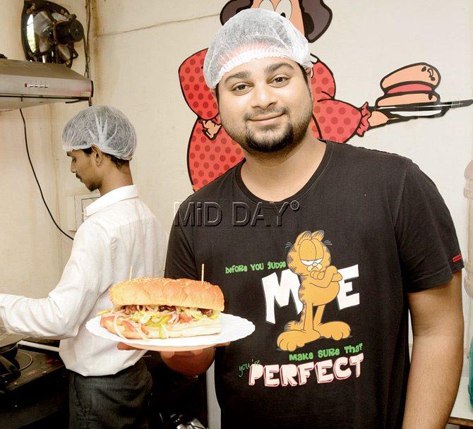 Studio owner Caleib Veigas serves up a grilled chicken sandwich for a customer at Maakapow  in Khar.  Pic/Satej Shinde