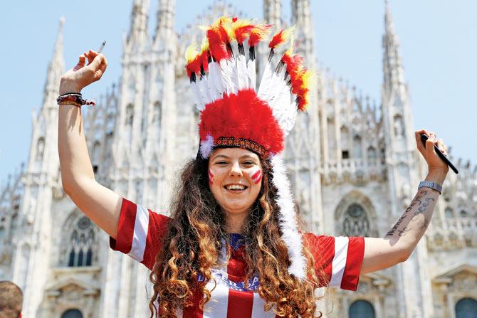Colour me red: An Atletico Madrid fan enjoys the atmosphere at Piazza Duomo in Milan
