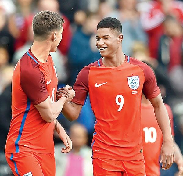 England’s Marcus Rashford (right) celebrates a goal with teammate during the friendly against Australia in Sunderland on Friday. Pic/AFP