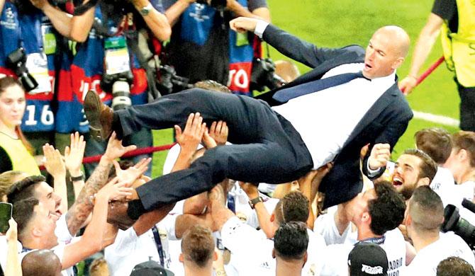 Zinedine Zidane is hoisted in the air by Real Madrid players. Pic/AP