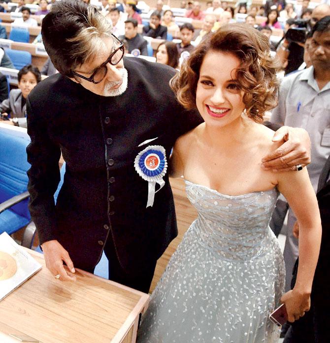 Kangana Ranaut and Amitabh Bachchan share a light moment at the 63rd National Awards ceremony in New Delhi yesterday
