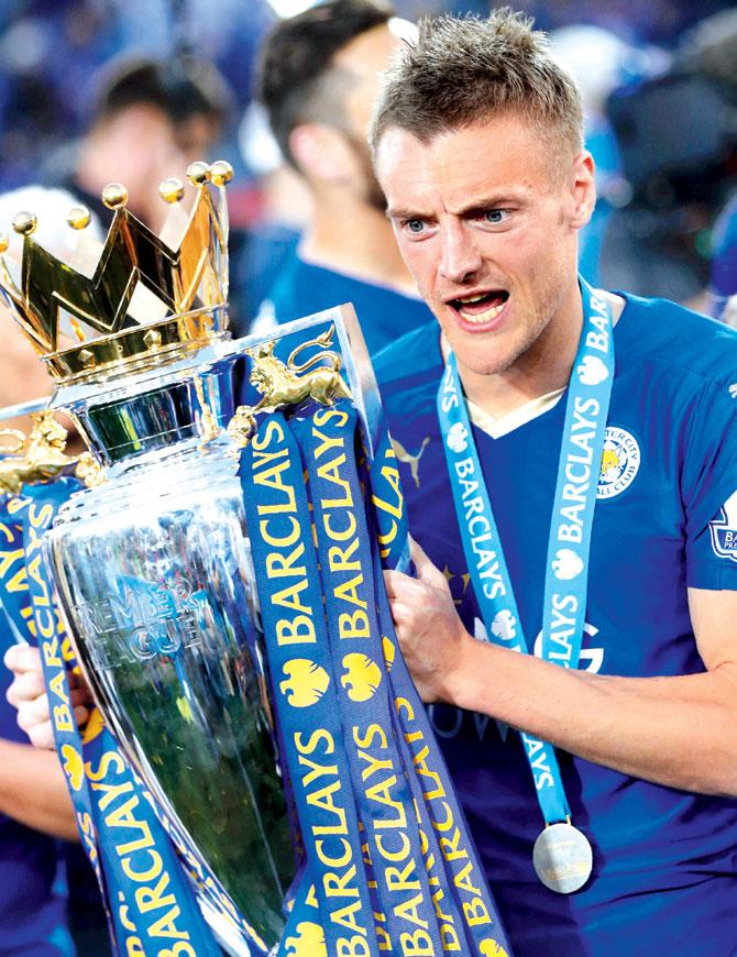 Striker Jamie Vardy poses with the trophy