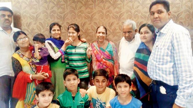 Ashmita Jain of St Joseph High School in New Panvel, who scored 99.6 per cent, celebrates with her family