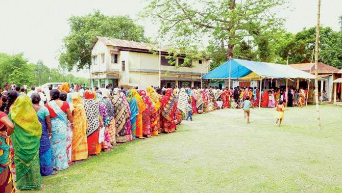 Erstwhile Bangladeshi enclave dwellers wait in a long queue to cast their votes for the first time at a polling station during the final phase of West Bengal Assembly elections in Coochbehar. Pic/PTI