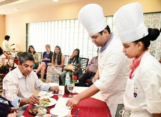 Chef Floyd Cardoz (left, seated) judges a culinary competition at a Bandra college. Pic/Shadab Khan