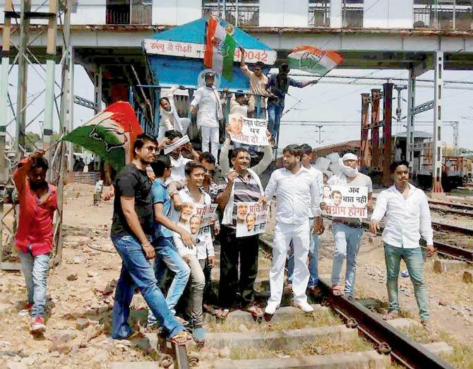 Congress workers stop a train while protesting against the AgustaWestland Chopper scam near Allahabad Railway Station on Saturday. Pic/PTI