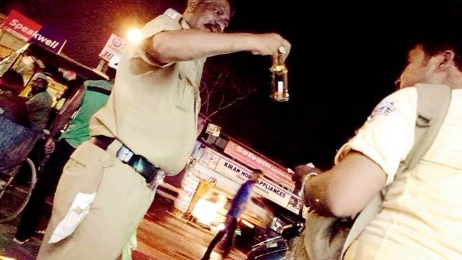 Constable AR Pawar latches onto his liquor bottle