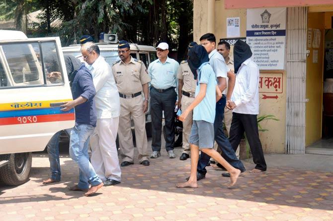 The accused staffers from University of Mumbai being taken into police custody on Saturday. Pic/Rajesh Gupta