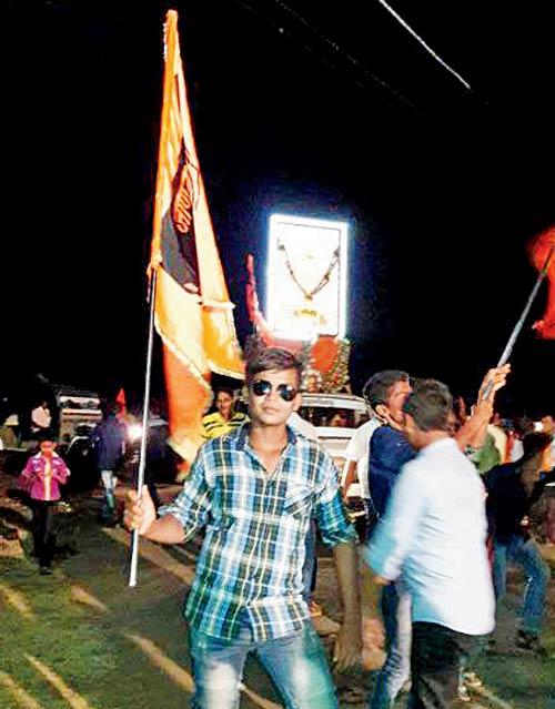 A photo of Faisal holding a saffron-coloured flag during Shiv Jayanti
