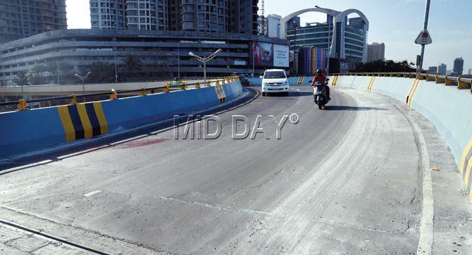 Wednesday: mid-day went back to the same spot, where one lane had already been repaired. A white powder was sprinkled there to help the surface dry faster. Pics/Nimesh Dave