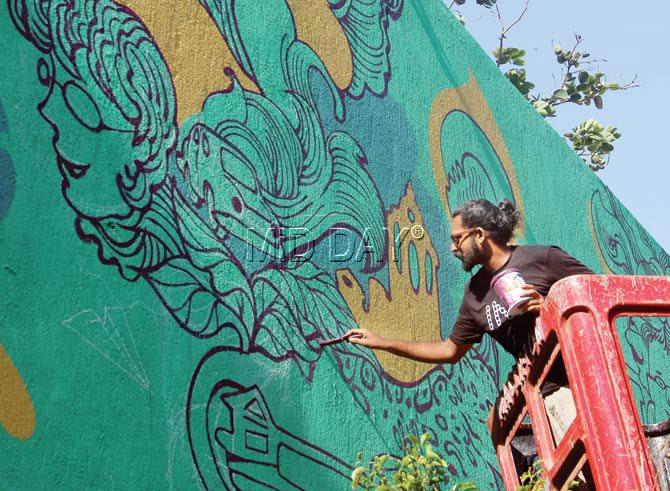 Artist Harshvardhan Kadam paints the compound wall of Planet Godrej to mark the launch of the Byculla Memory Project on Monday. Pics/Ajinkya Sawant