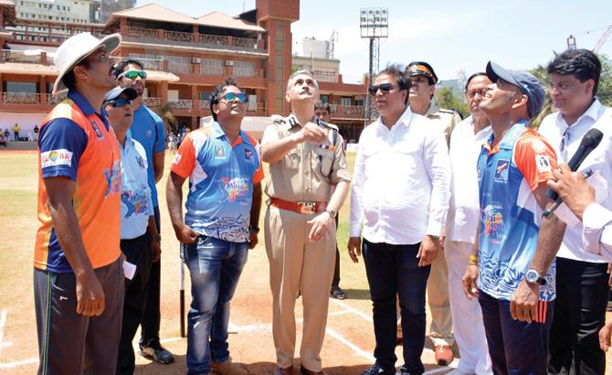 Mumbai Police Commissioner Dattatray Padsalgikar tosses the coin at the inaugural match of Jwala Foundation-organised T20 tourney at the Police Gymkhana on Monday