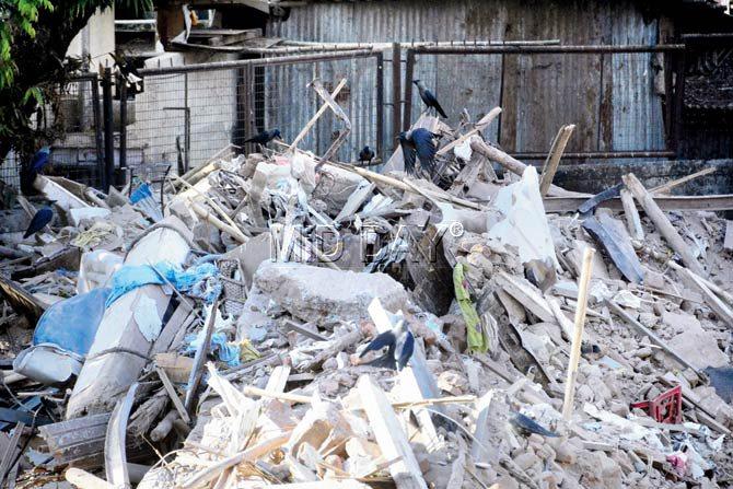 Debris from the mishap site dumped by the BMC at an open plot of a municipal eye hospital in Kamathipura yesterday. Pic/Bipin Kokate