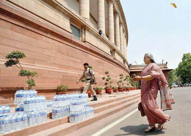 Rajya Sabha MP Jaya Bachchan makes her way to Parliament as water bottles are kept along the steps on a hot day. Pic/PTI