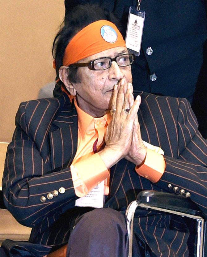 Veteran actor Manoj Kumar greets the audience as he arrives in a wheelchair to receive the Dadasaheb Phalke Award at the 63rd National Film Awards 2015 function in New Delhi. Pic/PTI
