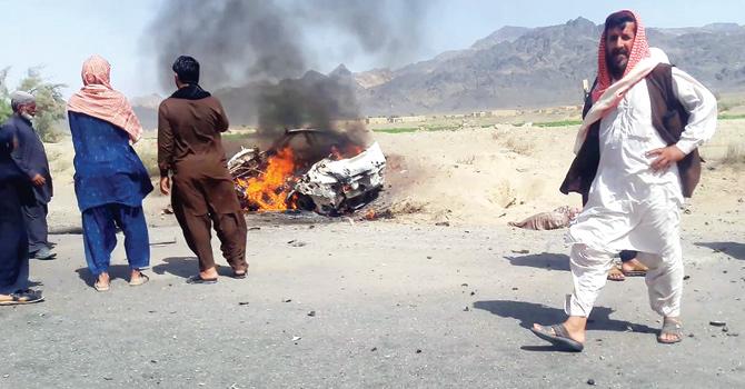 Locals gather around a vehicle hit by a drone strike in which Afghan Taliban chief Mullah Akhtar Mansour was believed to be travelling in Ahmad Wal. Pics/AFP
