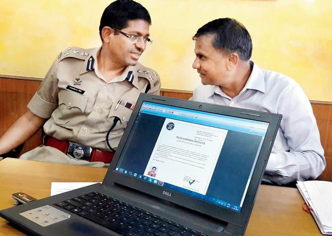 Additional CP RD Shinde (left) and DCP Ankush Shinde (right) showing the website for the police clearance certificate