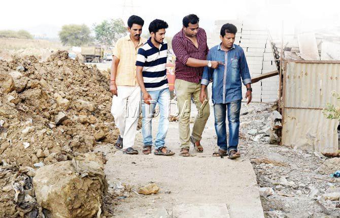 Salim Charania of Peace for Animals Welfare Association (centre), complainant in the case Shubhang Sharma (striped tee) and friends inspect the Mira Road site where 15 strays were allegedly poisoned. Pic/Nimesh Dave