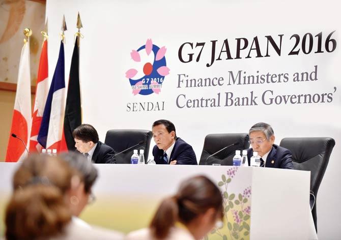 Japanese Finance Minister Taro Aso (c), Governor of the Bank of Japan Haruhiko Kuroda (r) and Vice Finance Minister Masatsugu Asakawa (l) answer questions after the G7 Finance Ministers and Central Bank Governors’ Meeting on Friday. Pic/AFP