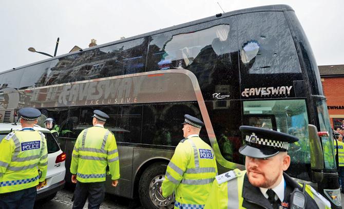 The bus carrying the Manchester United team is escorted by police after a window was smashed on its way to West Ham’s Boleyn ground before their English Premier League match in London on Tuesday. Pic/AFP