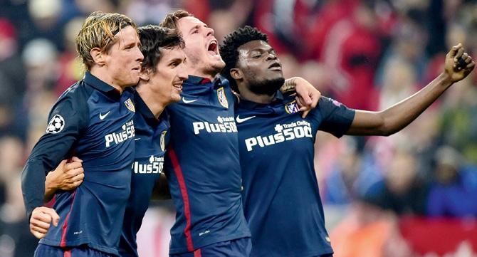 Atletico Madrid’s Fernando Torres (extreme left) celebrates with teammates after the Champions League semi-final second leg against Bayern Munich in Munich on Tuesday. Pic/AFP