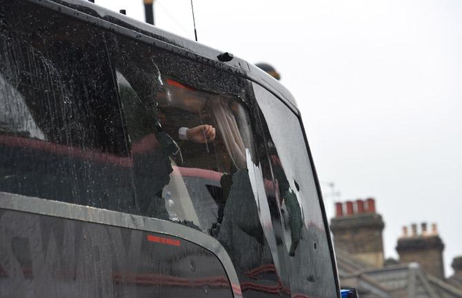 he bus carrying the Manchester United team is escorted by police after having a window smashed